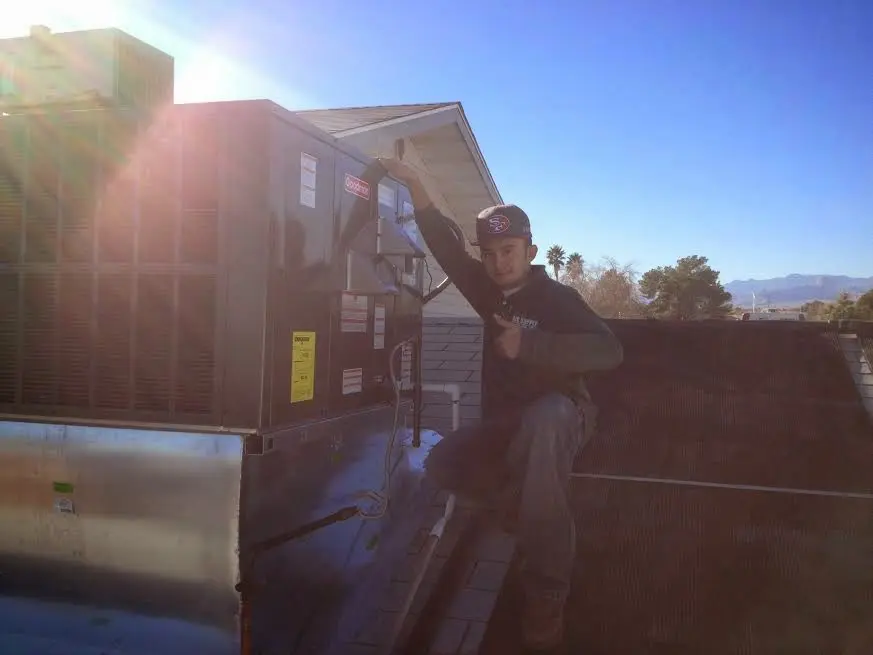 HVAC technician performing HVAC Inspection on a rooftop unit in Westminster